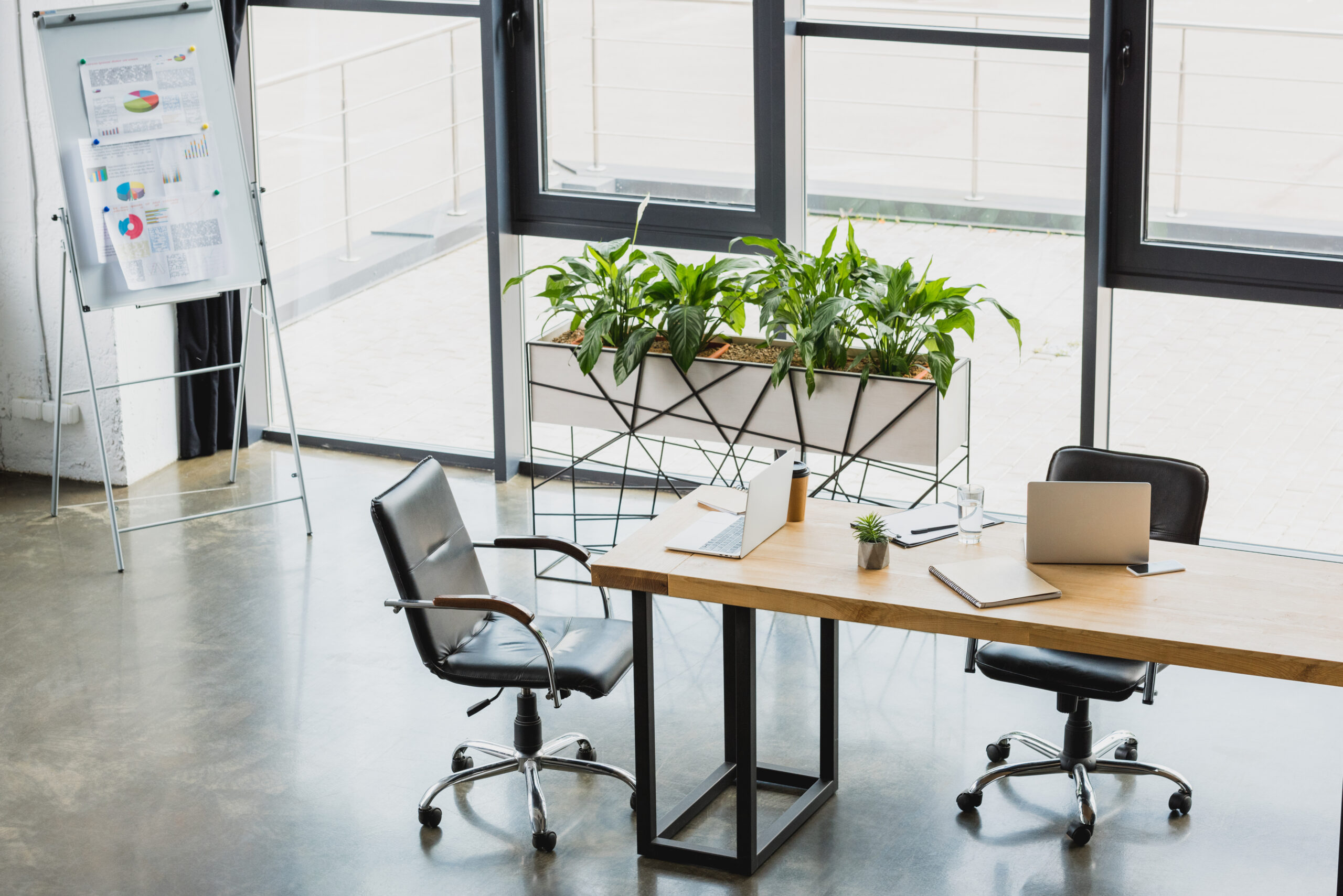 high angle view of modern office interior with electronics and business charts